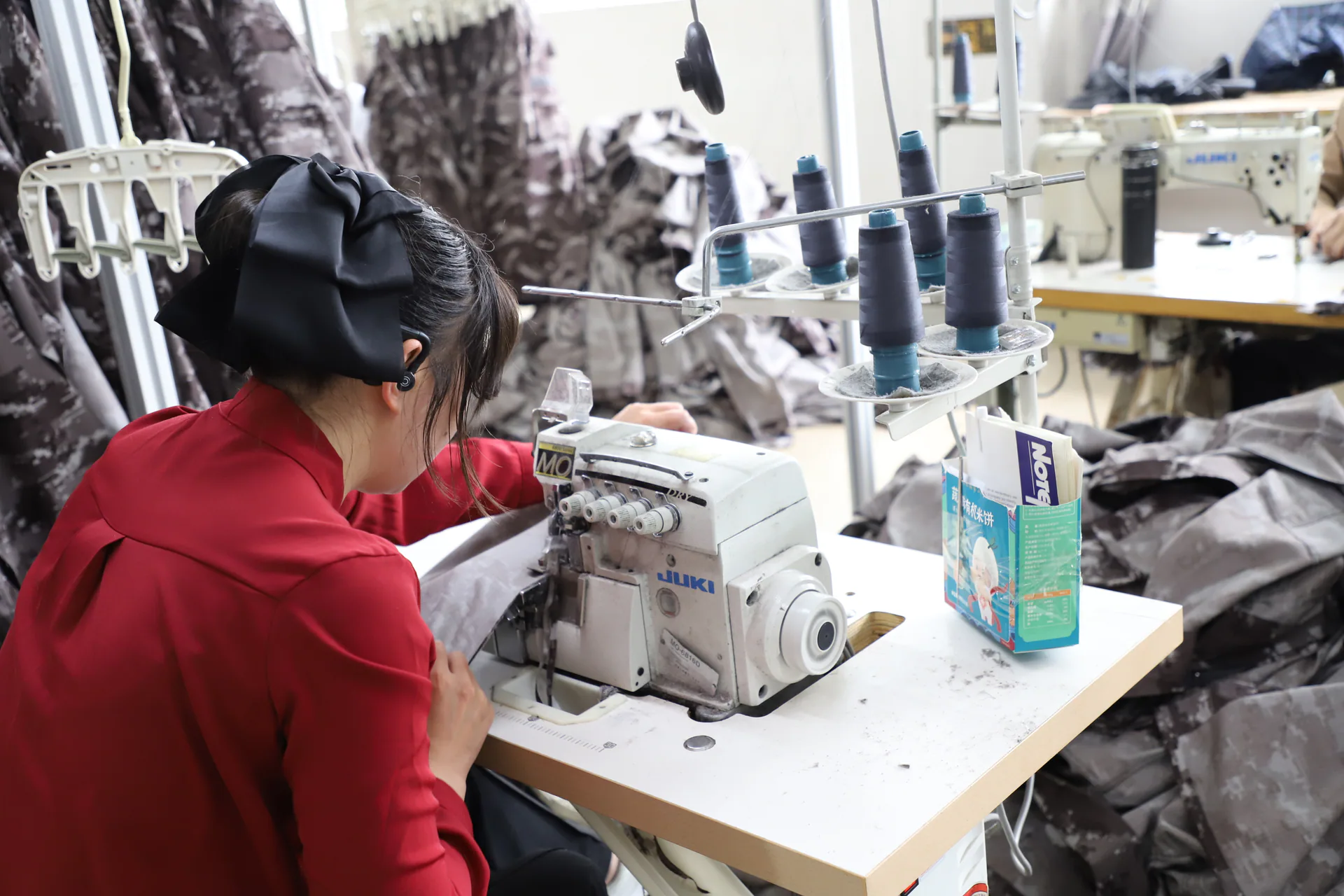 Garment sewing and assembly workstation in a Wuhan Jinteng production area